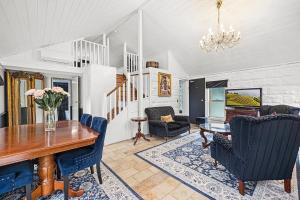 a dining room with a table and chairs at A Loft In The Mill Boutique Accommodation in Olinda