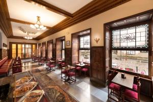 a restaurant with tables and chairs in a room at Miranda & Suizo in San Lorenzo de El Escorial