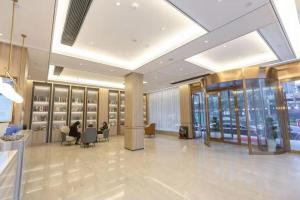 a lobby with people sitting in chairs in a building at Morninginn, Chenzhou Guiyang in Guiyang