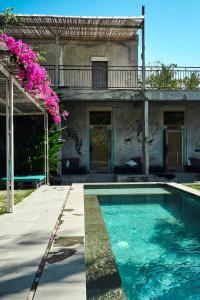 two pictures of a house with a swimming pool at LoTide Surf Camps Lombok in Kuta Lombok