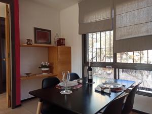 a dining room with a table and chairs and windows at Lara in Mendoza