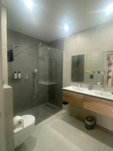 a bathroom with a shower and a toilet and a sink at Above the beach, 10 min from the city center - Casa da Tartaruga in Lagos +45 photos