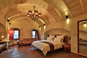 A bed or beds in a room at Ariana Sustainable Luxury Lodge - Special Category - Cappadocia