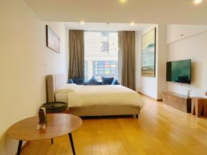 a hotel room with a bed and a table at Boutique houtel Shanghai Lujiazui in Shanghai