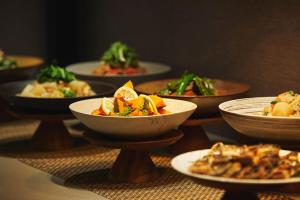 a group of bowls of food on a table at hotel MONday KYOTO MARUTAMACHI in Kyoto