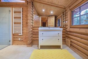 a bathroom with a sink in a log cabin at Beach & Golf Retreat w Amazing pool, By TimeCooler in Aroeira