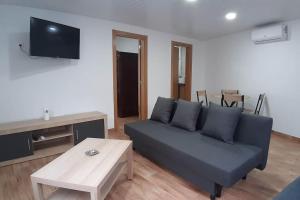 a living room with a couch and a table at Villa T2 Maçussa - 45min Lisbon in Massuça