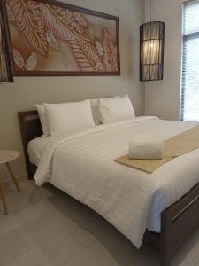 Ένα ή περισσότερα κρεβάτια σε δωμάτιο στο Rebungan Resort Langkawi