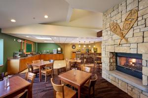 a restaurant with tables and a fireplace at Mountain Valley Lodge Hailey Sun Valley in Hailey