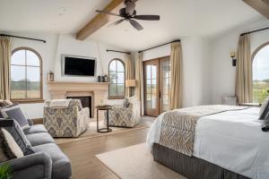 a large bedroom with a bed and a fireplace at Grand Reserve Inn in Plymouth