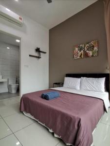 a bedroom with a large bed and a bathroom at Conezion Residence Putrajaya WiFi Netflix in Putrajaya
