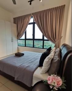 a bedroom with a large bed with a large window at Conezion Residence Putrajaya WiFi Netflix in Putrajaya