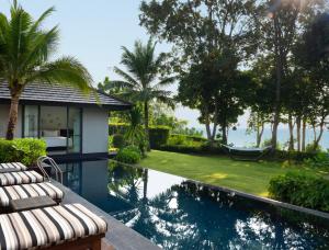 a villa with a swimming pool and a resort at The ShellSea Krabi I Luxury Beach Front Resort & Pool Villa in Ao Nam Mao