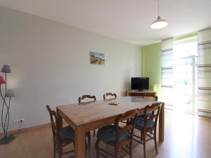 a dining room with a wooden table and chairs at Bel appartement 3*** La Bourboule, 6 pers, Wifi inclus - FR-1-608-250 in La Bourboule +8 photos