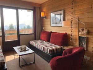 a living room with a couch and a chair at Appartement Avoriaz, 3 pièces, 7 personnes - FR-1-634-89 in Morzine