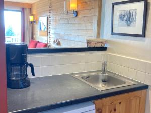 a kitchen with a sink and a coffee maker on a counter at Appartement pour 6/7 personnes avec balcon, animaux acceptés, internet, casier à skis - FR-1-634-89 in Morzine +8 photos