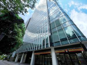 a tall glass building with a lot of windows at Hotel GrandBach Sendai in Sendai