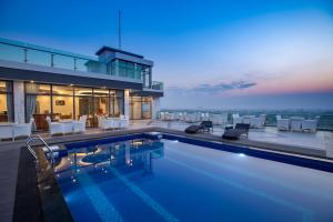 a house with a swimming pool on top of a building at Havana Hotel Mandalay in Mandalay