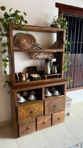 a wooden book shelf with pots and dishes on it at HOTEL PLAZA BOLIVAR MOMPOX ubicado en el centro histórico con parqueadero interno in Mompos