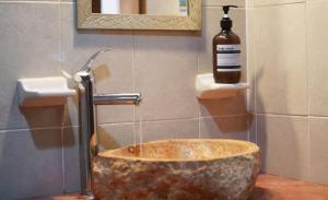 a bathroom with a stone sink and a bottle of soap at Habitacion Roja / Casa del Café in Campeche +14 photos