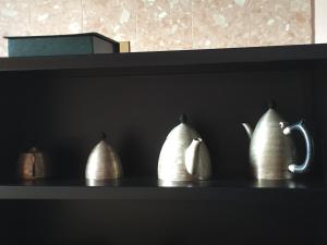 a shelf with four white vases on it at Molino Stucky Flat in Venice
