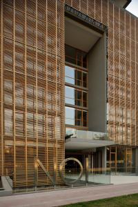 a facade of a building with wooden slats at NOI Vitacura in Santiago