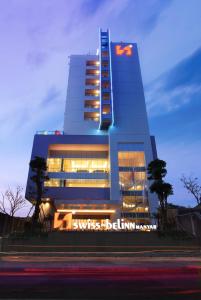 a building with a sign on the side of it at Swiss-Belinn Manyar in Surabaya