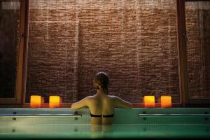 a woman in a swimming pool looking out a window at NOI Vitacura in Santiago
