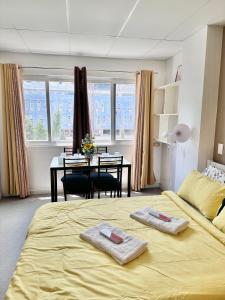 a bedroom with a bed with two towels on it at Smart Condominium in Cagayan de Oro City in Cagayan de Oro +35 photos