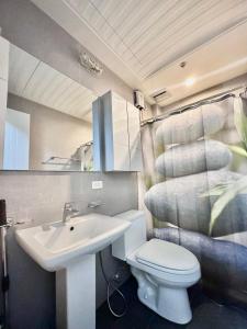 bagno con servizi igienici bianchi e lavandino di Smart Condominium in Cagayan de Oro City a Cagayan de Oro