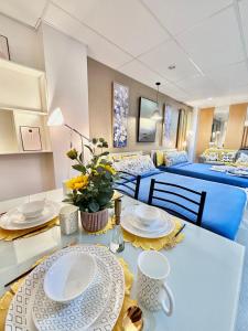 a room with two beds and a table with plates at Smart Condominium in Cagayan de Oro City in Cagayan de Oro