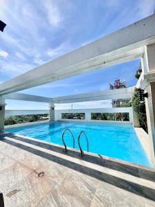 a swimming pool with a pair of tongs in the middle at Smart Condominium in Cagayan de Oro City in Cagayan de Oro