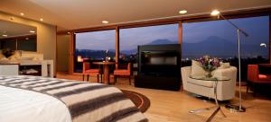 a hotel room with a bed and a large window at NOI Vitacura in Santiago
