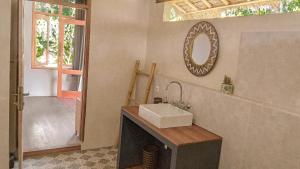a bathroom with a sink and a mirror on the wall at Les Rizieres Lombok - Tetebatu in Tetebatu