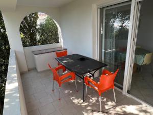 a patio with a table and chairs on a balcony at Apartments MiaMaja in Novalja