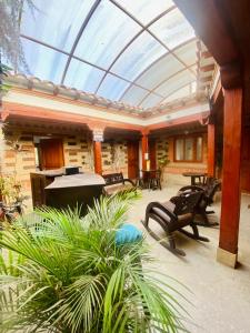 a conservatory with a glass roof over a patio at Hotel Oasis de la villa in Villa de Leyva