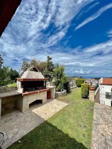 a stone pizza oven sitting on top of a yard at #ALS- Stone Maisonette in Paliouri in Paliouri