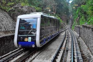 a blue and white train on the tracks at AAA Homestay Georgetown Penang in Ayer Itam +9 photos
