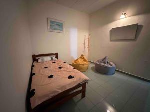 a bedroom with a bed in a room at AAA Homestay Georgetown Penang in Ayer Itam