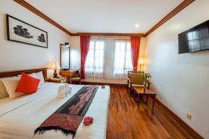 a hotel room with a bed and a television at Royal Crown Hotel & Spa in Siem Reap
