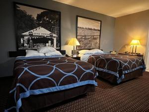 ein Hotelzimmer mit 2 Betten und 2 Lampen in der Unterkunft Super 8 by Wyndham Center in Center