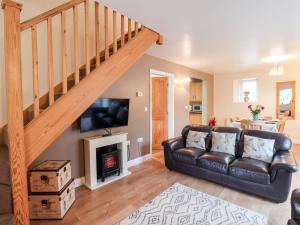 a living room with a couch and a fireplace at Mulgrave Cottage in Staithes