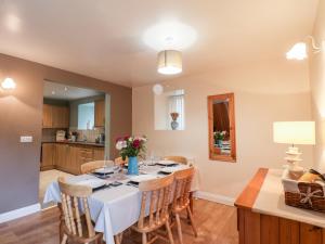 a kitchen and dining room with a table and chairs at Mulgrave Cottage in Staithes