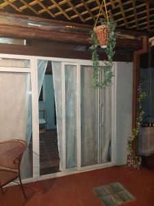 a room with a sliding glass door with a chair at Nirvana 2, Habitación doble con todos sus servicios in Guatemala