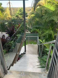 a stairway leading up to a resort with palm trees at Central Oasis in Coffs Harbour