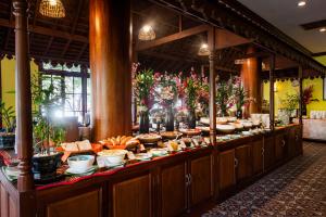 a buffet line with bowls and plates of food at Royal Crown Hotel & Spa in Siem Reap