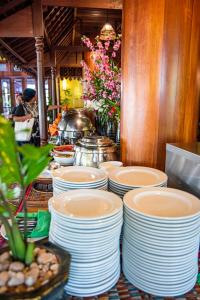 a group of white plates sitting on a table at Royal Crown Hotel & Spa in Siem Reap