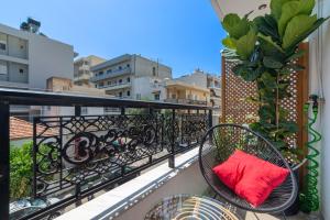 a balcony with a red pillow on a balcony at Evangeline City Center Apartment AC/WiFi in Heraklio