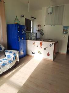 een slaapkamer met een bed en een blauwe koelkast bij NEREA house in Lido di Ostia