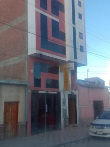 a building with a painting on the side of it at Hostal Sin fronteras in Uyuni +8 photos